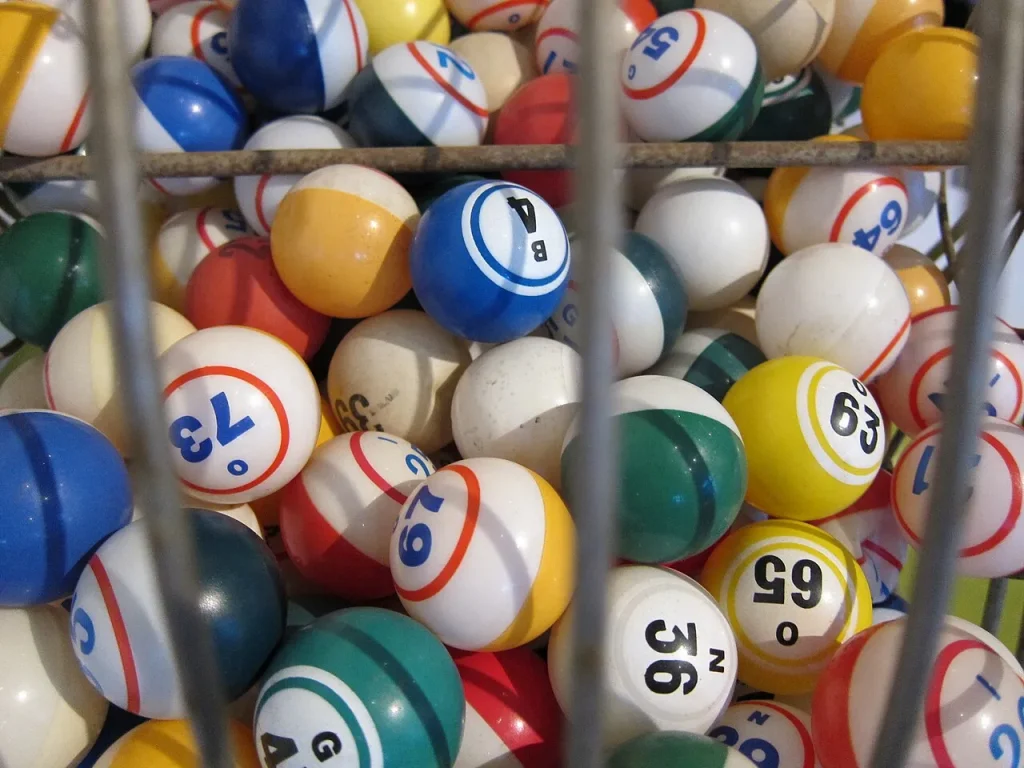 How a Powerball Jackpot Grows: Rollovers, Ticket Sales and $562 Million Numbered lottery balls tumbling inside a transparent draw drum