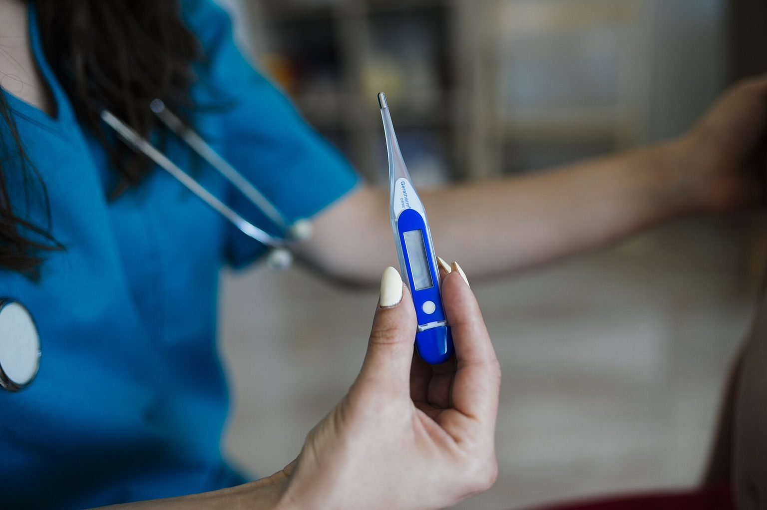 Lung Cancer Screening: Who Should Get It and Why Uptake Lags Healthcare professional checks temperature with digital thermometer during patient consultation in a medical office undefined